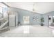 Bright living room featuring tiled floors and staircase leading to upper floors, full of natural light at 4270 Boston Cir, New Port Richey, FL 34653