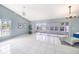Bright living room featuring tile flooring and sliding glass doors to outdoor space at 4270 Boston Cir, New Port Richey, FL 34653