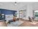 Bright bedroom with blue accent wall, neutral decor, wood floors and a modern sliding door to a walk-in closet at 430 Hickory Nut, Oldsmar, FL 34677