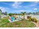 Landscaped backyard featuring a fire pit surrounded by colorful Adirondack chairs at 5103 Rushbrook Rd, Land O Lakes, FL 34638
