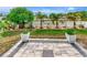 Landscaped backyard with a paved patio, white fence, and tropical plants offers a private outdoor space at 5103 Rushbrook Rd, Land O Lakes, FL 34638