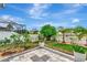 Well-maintained backyard featuring a patio, tropical landscaping, and white fence, creating a serene outdoor space at 5103 Rushbrook Rd, Land O Lakes, FL 34638