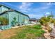 Backyard with well-maintained lawn and garden beds, bordered by a white picket fence at 5103 Rushbrook Rd, Land O Lakes, FL 34638