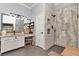 Nicely designed bathroom with gray-tiled shower, modern vanity, and bright light fixtures at 5103 Rushbrook Rd, Land O Lakes, FL 34638