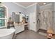 Bright bathroom with dual sinks, standalone shower, and soaking tub under a window with great light at 5103 Rushbrook Rd, Land O Lakes, FL 34638