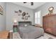 Cozy bedroom with hardwood floors, a murphy bed, and charming decorative accents at 5103 Rushbrook Rd, Land O Lakes, FL 34638