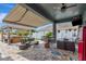 Inviting covered patio with outdoor seating, a bar, and a hot tub for relaxation and entertaining at 5103 Rushbrook Rd, Land O Lakes, FL 34638