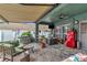 Relaxing covered patio with a retro refrigerator, patio set, and built in BBQ area at 5103 Rushbrook Rd, Land O Lakes, FL 34638