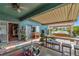 Outdoor living with a covered patio, complete with bar, seating, hot tub and vibrant decor at 5103 Rushbrook Rd, Land O Lakes, FL 34638