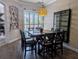 Elegant dining room with a modern light fixture and dark wood furniture, perfect for Gathering gatherings at 5103 Rushbrook Rd, Land O Lakes, FL 34638