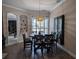 Elegant dining room with a modern light fixture and dark wood furniture, perfect for Gathering gatherings at 5103 Rushbrook Rd, Land O Lakes, FL 34638