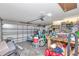 Garage with an overhead door, a scooter, a workbench, and various storage containers at 5103 Rushbrook Rd, Land O Lakes, FL 34638