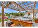Outdoor hot tub with a wooden pergola and patio furniture, creating a luxurious spa-like experience at 5103 Rushbrook Rd, Land O Lakes, FL 34638