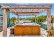 Inviting backyard hot tub with a wooden pergola and string lights creates a relaxing outdoor oasis at 5103 Rushbrook Rd, Land O Lakes, FL 34638