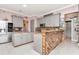 Bright kitchen with stainless steel appliances, granite countertops, and a unique wooden accent bar at 5103 Rushbrook Rd, Land O Lakes, FL 34638