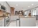 Open-concept kitchen with stainless steel appliances flows seamlessly into the dining and living areas at 5103 Rushbrook Rd, Land O Lakes, FL 34638