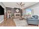 Bright living room with stone fireplace, ceiling fan, and comfortable seating with great natural light at 5103 Rushbrook Rd, Land O Lakes, FL 34638