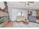Open concept living room features a fireplace, hardwood floors, neutral paint, and lots of natural light at 5103 Rushbrook Rd, Land O Lakes, FL 34638