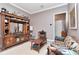 Cozy living room features a large wooden cabinet with mirror and decorative accents and a comfortable floral couch at 5103 Rushbrook Rd, Land O Lakes, FL 34638