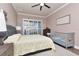 Cozy bedroom with a large window, crown molding, and neutral paint at 5103 Rushbrook Rd, Land O Lakes, FL 34638