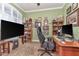 Home office with ample desk space, built-in shelving, and natural light from the window at 5103 Rushbrook Rd, Land O Lakes, FL 34638