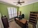 This room features a wood-paneled desk, built-in bookshelves, and a window with plantation shutters at 5103 Rushbrook Rd, Land O Lakes, FL 34638