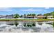 Beautiful pond view reflecting the houses, sky and palm trees, creating a serene backdrop at 5103 Rushbrook Rd, Land O Lakes, FL 34638