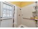 Shower area with white tiles, shower head, safety bar, and a door to the backyard at 5103 Rushbrook Rd, Land O Lakes, FL 34638