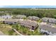 Aerial view of the backyard of the townhomes with a patio, screened in porch, and walking path at 5103 San Martino Dr, Wesley Chapel, FL 33543