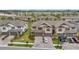 Aerial view of newly built townhomes featuring attached garages, neutral exteriors, and well-maintained landscaping at 5103 San Martino Dr, Wesley Chapel, FL 33543