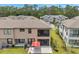The backyard features a patio with an umbrella, a screened in porch, and a lush green lawn at 5103 San Martino Dr, Wesley Chapel, FL 33543