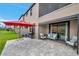 Backyard featuring a patio, red umbrella, grill, and outdoor seating area at 5103 San Martino Dr, Wesley Chapel, FL 33543