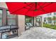 Backyard featuring a patio, red umbrella, grill, and outdoor seating area at 5103 San Martino Dr, Wesley Chapel, FL 33543