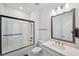 Modern bathroom featuring a shower over tub with glass enclosure, contemporary vanity and lighting at 5103 San Martino Dr, Wesley Chapel, FL 33543