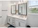 Bathroom features a double sink vanity with framed mirrors and modern fixtures at 5103 San Martino Dr, Wesley Chapel, FL 33543