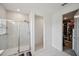 Bathroom featuring a glass shower with tile, and a closet with racks and shelves at 5103 San Martino Dr, Wesley Chapel, FL 33543