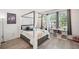 Cozy bedroom with gray canopy bed frame, playful decor, and lots of natural light at 5103 San Martino Dr, Wesley Chapel, FL 33543