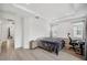 Bright bedroom features tray ceiling, wood floors, and neutral walls at 5103 San Martino Dr, Wesley Chapel, FL 33543
