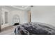 Bright bedroom features tray ceiling, wood floors, and neutral walls at 5103 San Martino Dr, Wesley Chapel, FL 33543