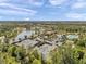 Expansive aerial view of a community featuring tennis courts, a pool, and a scenic lake for leisure and recreation at 5103 San Martino Dr, Wesley Chapel, FL 33543