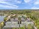 Wide aerial shot of a community with tennis courts, a pool, and a lake, offering a comprehensive lifestyle in a scenic setting at 5103 San Martino Dr, Wesley Chapel, FL 33543