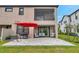 Rear exterior view of the home with a patio, balcony, and outdoor seating area at 5103 San Martino Dr, Wesley Chapel, FL 33543