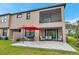 Rear exterior view of the home with a patio, balcony, and outdoor seating area at 5103 San Martino Dr, Wesley Chapel, FL 33543