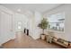 Open foyer featuring tile flooring, white walls, staircase, bench with tree, and natural light at 5103 San Martino Dr, Wesley Chapel, FL 33543