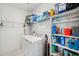 Well-organized laundry room with shelving, and modern washer and dryer at 5103 San Martino Dr, Wesley Chapel, FL 33543