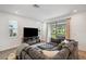 Bright living room with a large sofa, an entertainment center, and an outside view at 5103 San Martino Dr, Wesley Chapel, FL 33543