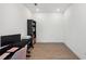 Bright office featuring black desk, rolling bookcase, and wood-look tile flooring at 5103 San Martino Dr, Wesley Chapel, FL 33543