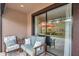 Inviting patio seating area with stylish outdoor furniture and sliding glass doors at 5103 San Martino Dr, Wesley Chapel, FL 33543