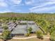 Aerial view of several community tennis courts with surrounding lush greenery, offering a peaceful recreation setting at 5103 San Martino Dr, Wesley Chapel, FL 33543