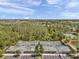 Wide aerial shot shows community tennis courts bordered by parking, trees, and residential homes, offering a dynamic lifestyle at 5103 San Martino Dr, Wesley Chapel, FL 33543